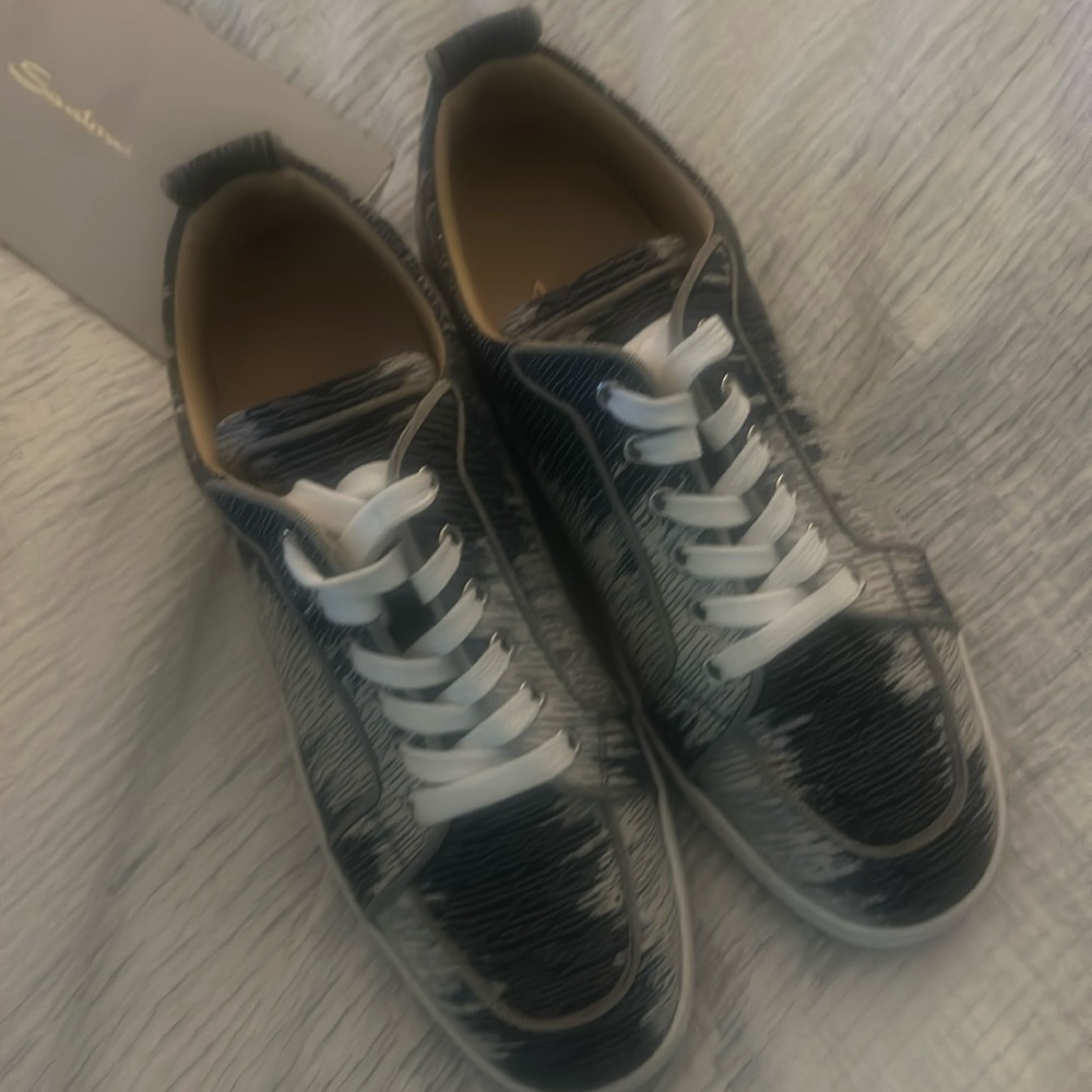 Designer tennis shoes by Christian Louboutin in excellent condition.